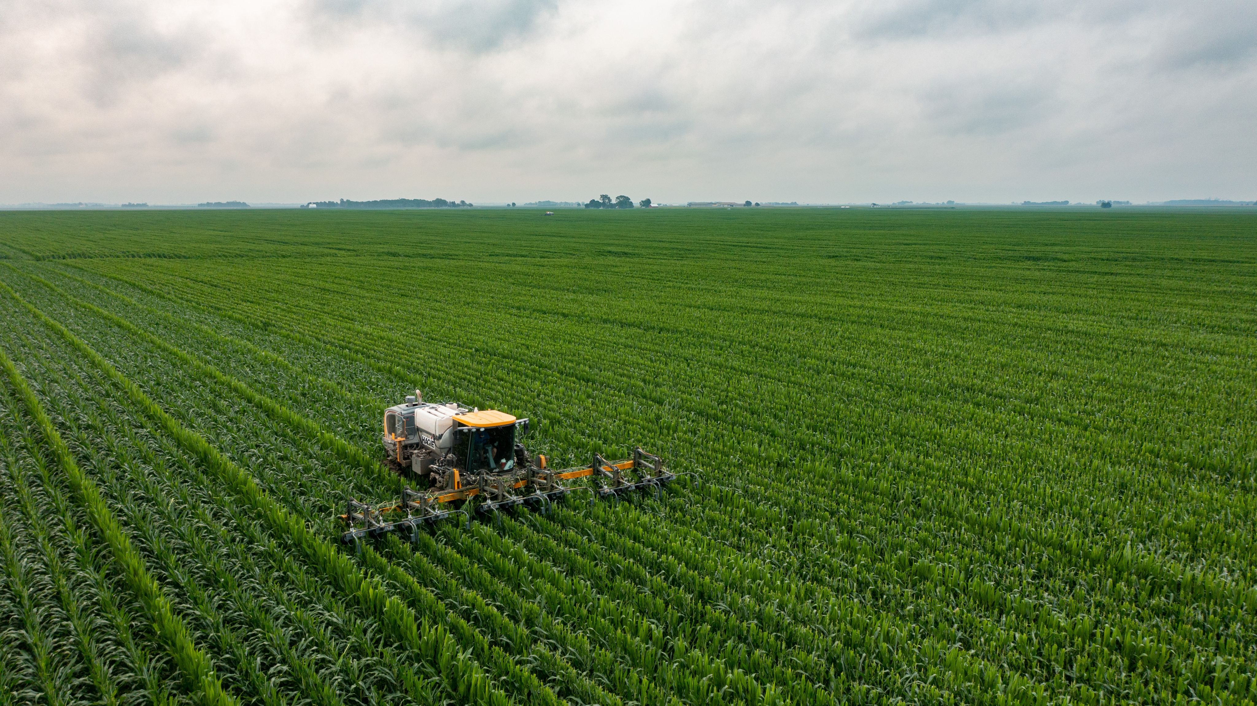 yellow and black tractor on green grass field during daytime